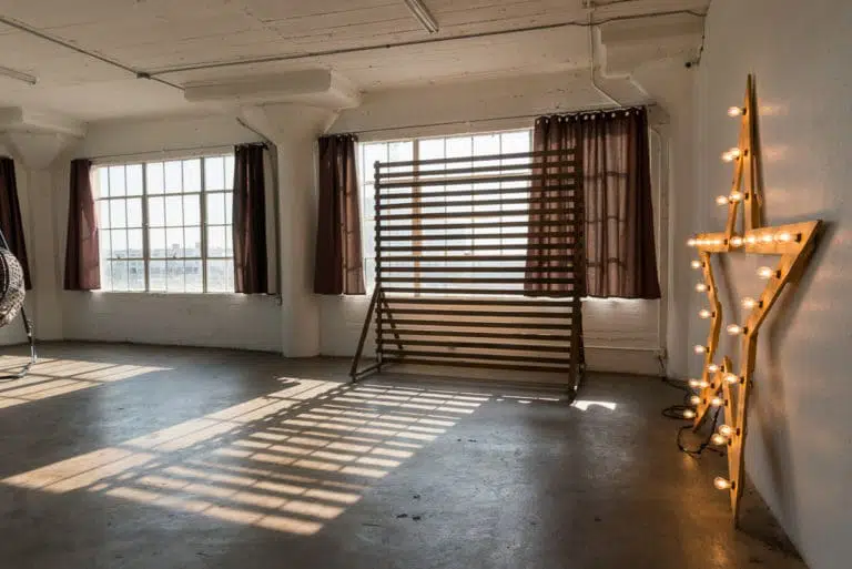 Stage with a wooden corner, large blinds and a marquee star available for rental in Los Angeles