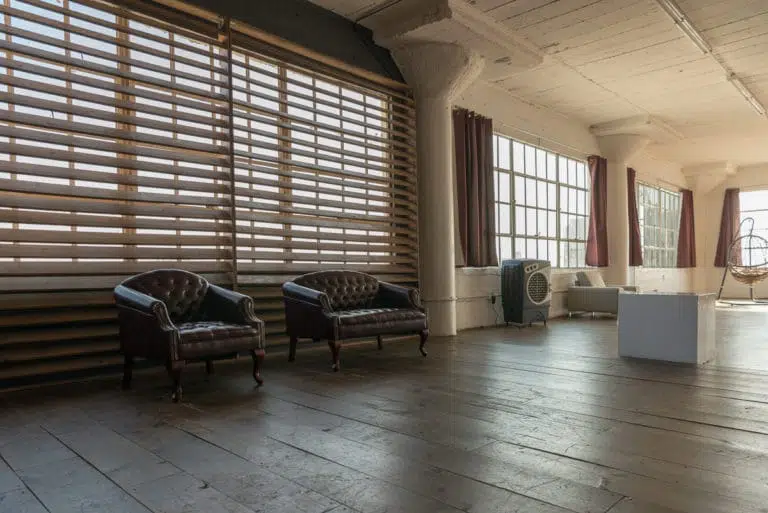 Stage with a wooden corner, large blinds and a marquee star available for rental in Los Angeles