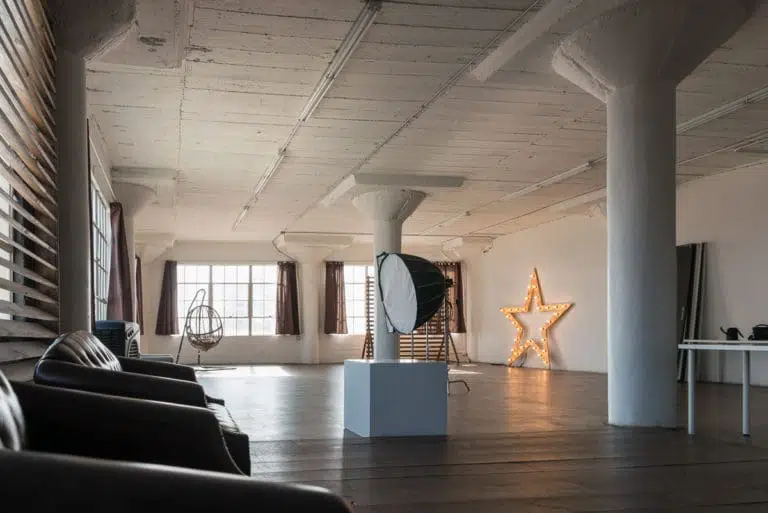 Stage with a wooden corner, large blinds and a marquee star available for rental in Los Angeles