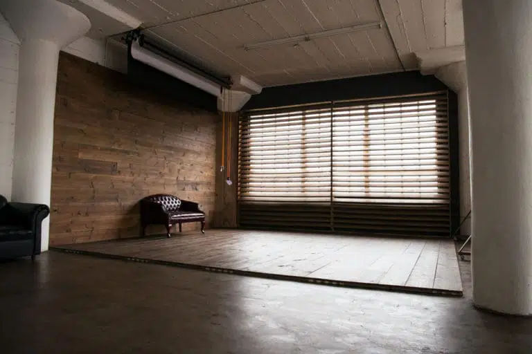 Stage with a wooden corner, large blinds and a marquee star available for rental in Los Angeles