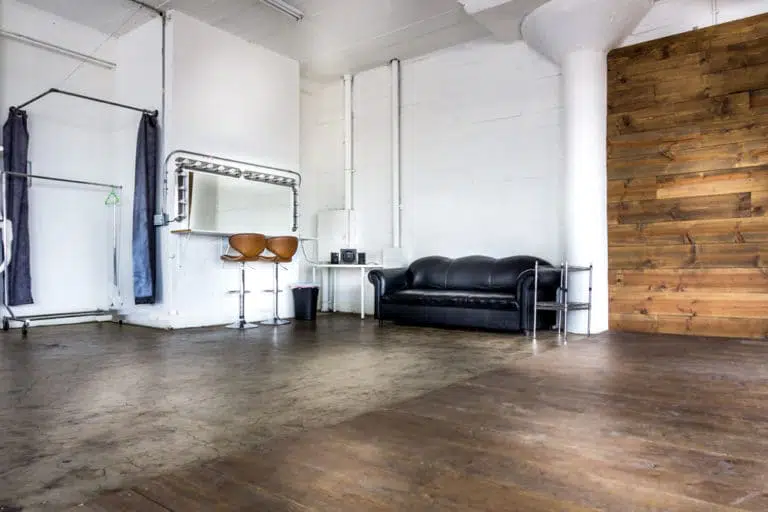 Stage with a wooden corner, large blinds and a marquee star available for rental in Los Angeles