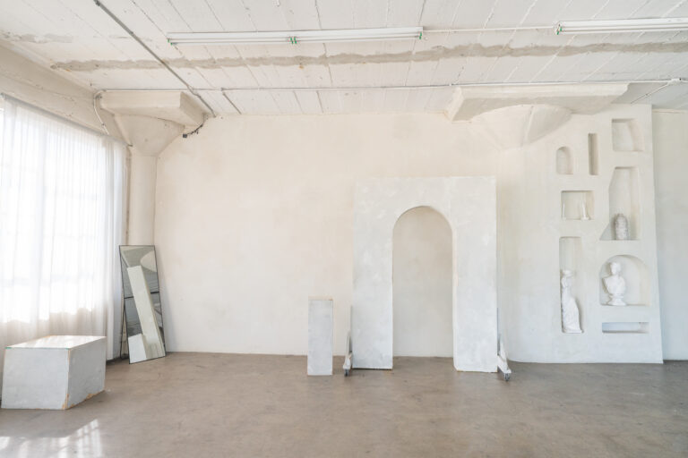 Stage with a wooden corner, large blinds and a marquee star available for rental in Los Angeles