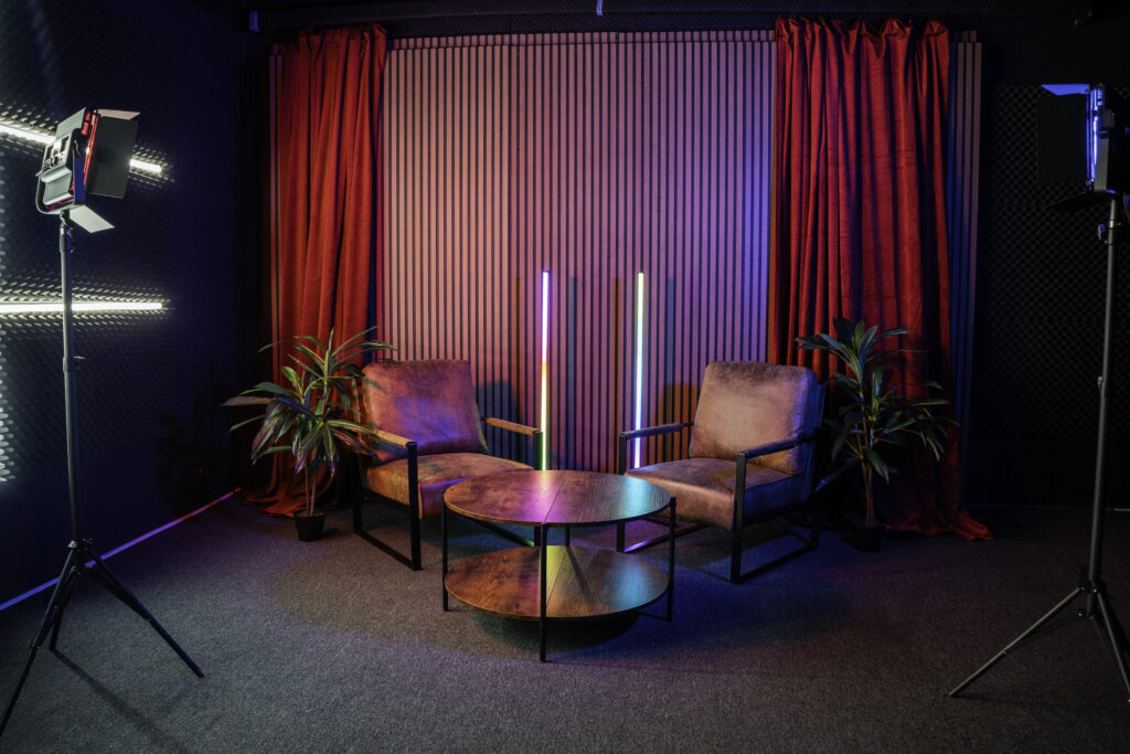 Soundproof Podcast Studio in DTLA with red curtains brick and wooden walls furniture RGB LED lights - Pro III_7