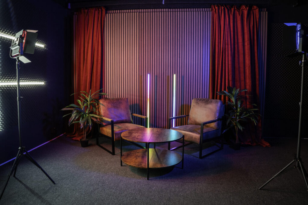 Soundproof Podcast Studio in DTLA with red curtains brick and wooden walls furniture RGB LED lights - Pro III_7