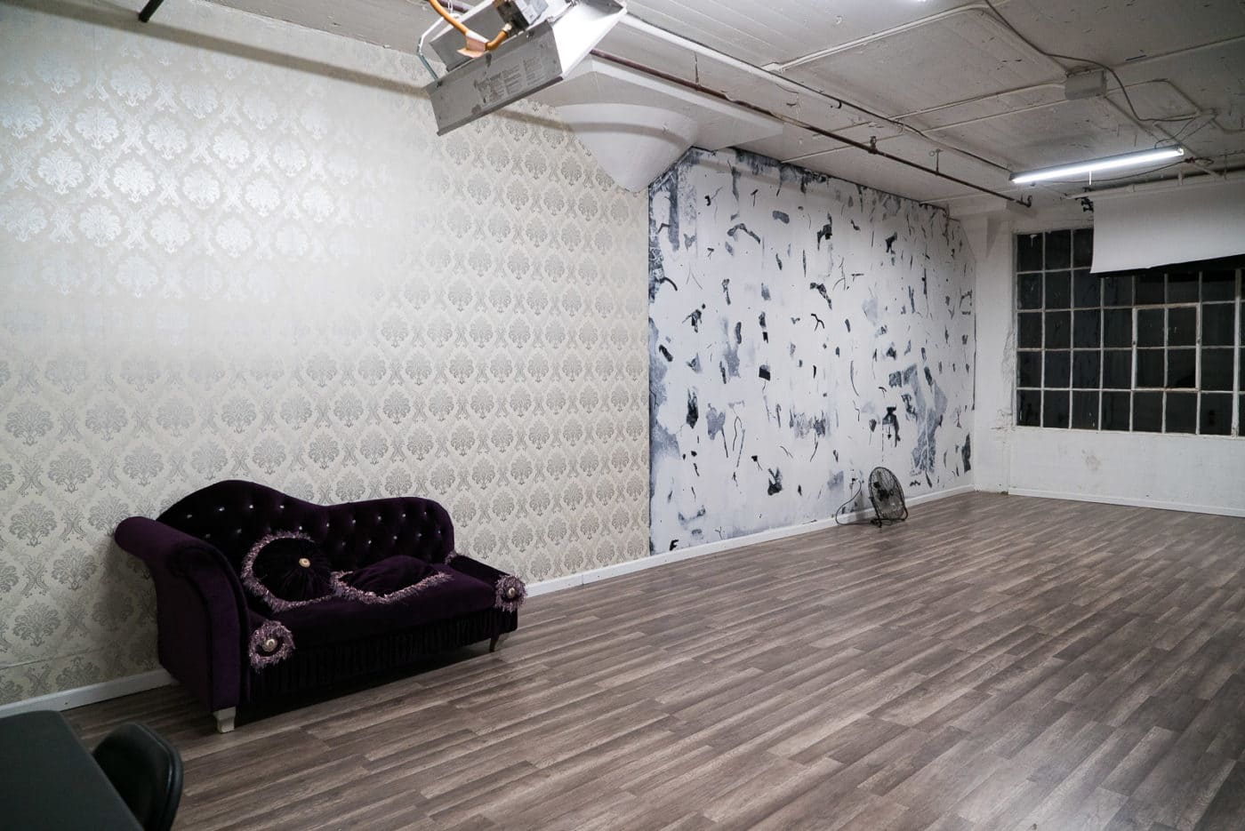 Medium size photo studio for rent in NY with large north facing window, included equipment and painted artistic wall