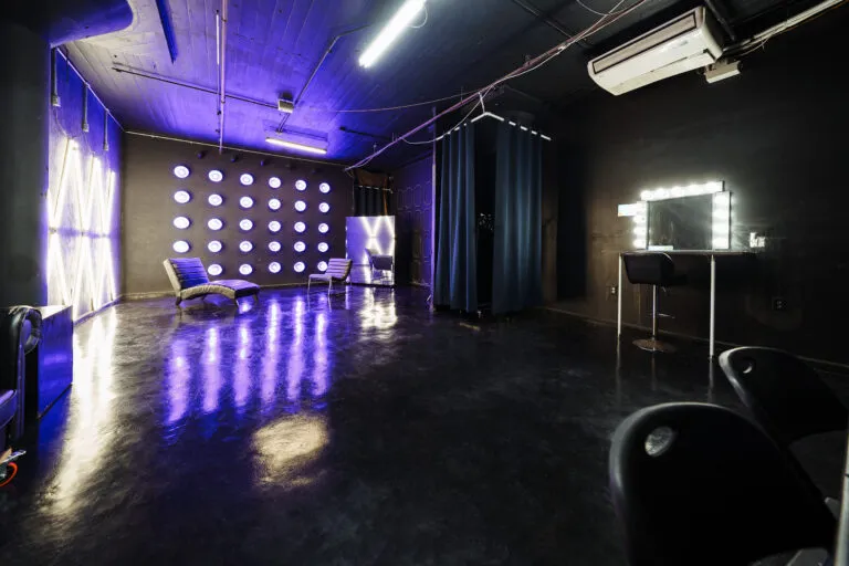 LIC 4 - a Blackout Studio for rent near me New York with RGB lights, X-lights, Concrete Wall, Black gloss floor and two different French Walls