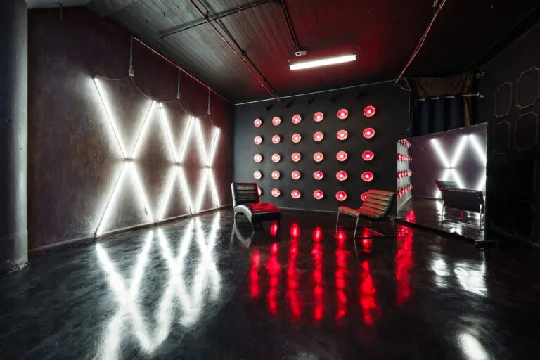 LIC 4 - a Blackout Studio for rent near me New York with RGB lights, X-lights, Concrete Wall, Black gloss floor and two different French Walls