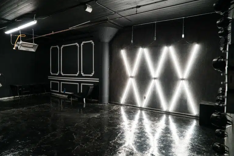 Affordable photo studio with 4 different sets, RGB lights, furniture and additional grip & strobes included, available for rent hourly near New York.