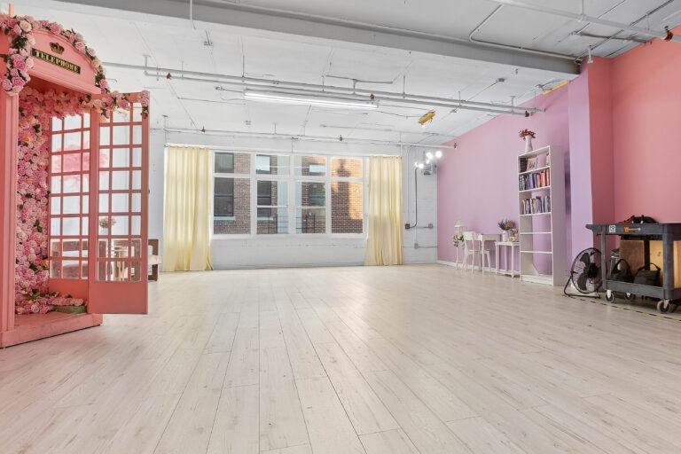 Rental photo studio with hardwood floors, big North facing window, and a pink photo booth - Astoria 3