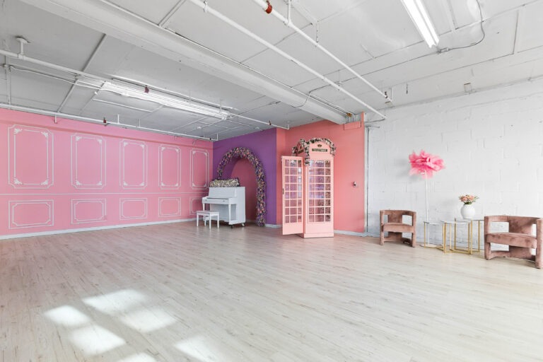 Rental photo studio with hardwood floors, big North facing window, and a pink photo booth - Astoria 3