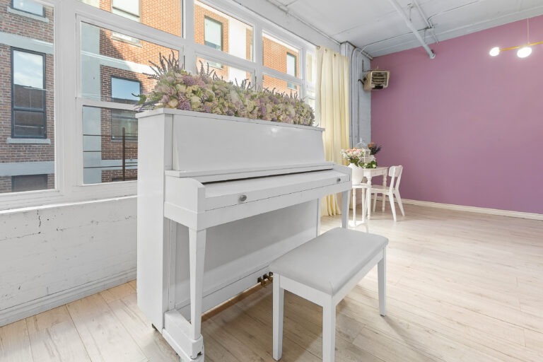 Rental photo studio with hardwood floors, big North facing window, and a pink photo booth - Astoria 3