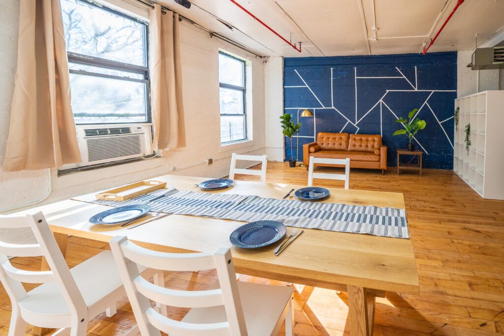 Astoria 5 - Daylight photo studio with kitchen, wood floor and cozy couch in New York