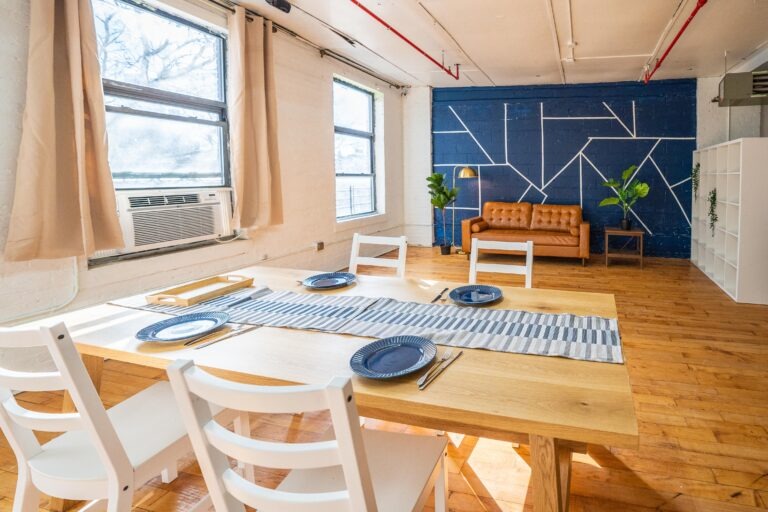 Astoria 5 - Daylight photo studio with kitchen, wood floor and cozy couch in New York