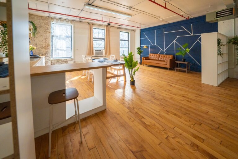 Astoria 5 - Daylight photo studio with kitchen, wood floor and cozy couch in New York