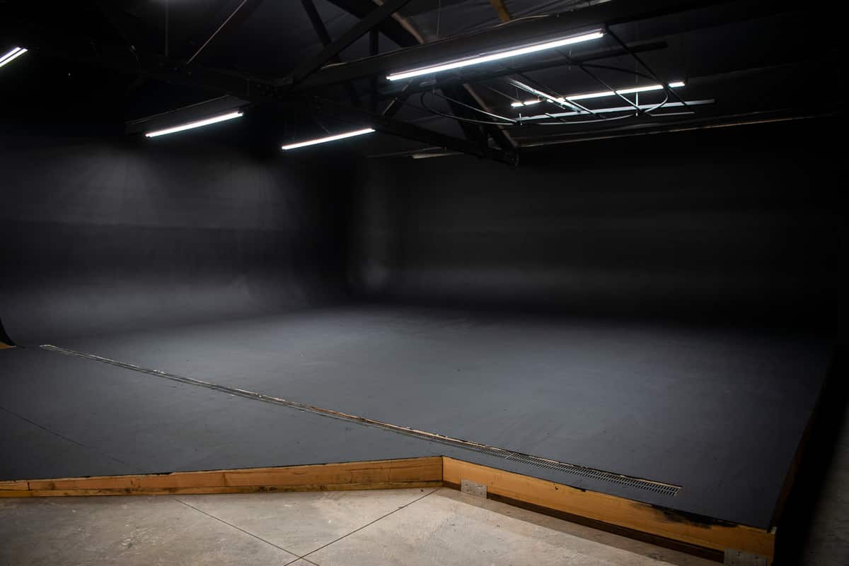 Car photo studio with large black cyc wall, rain feature and LED tunnel